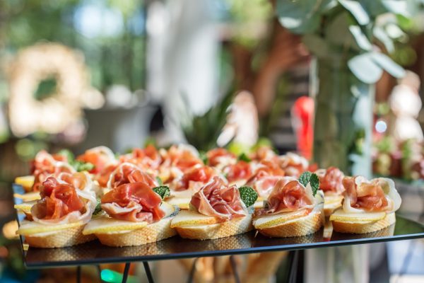 catering buffet table with snacks and appetizers. Set of canapés with jamon, bruschetta and cheese catering buffet table with snacks and appetizers. Set of canapés with jamon, bruschetta, pear and cheese and mint